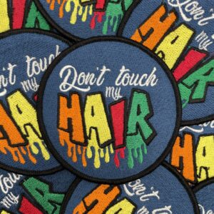 A pile of patches that say don 't touch my hair.