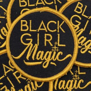 Black girl magic patch with gold stitching.