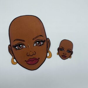 Two embroidered patches of a woman's face.