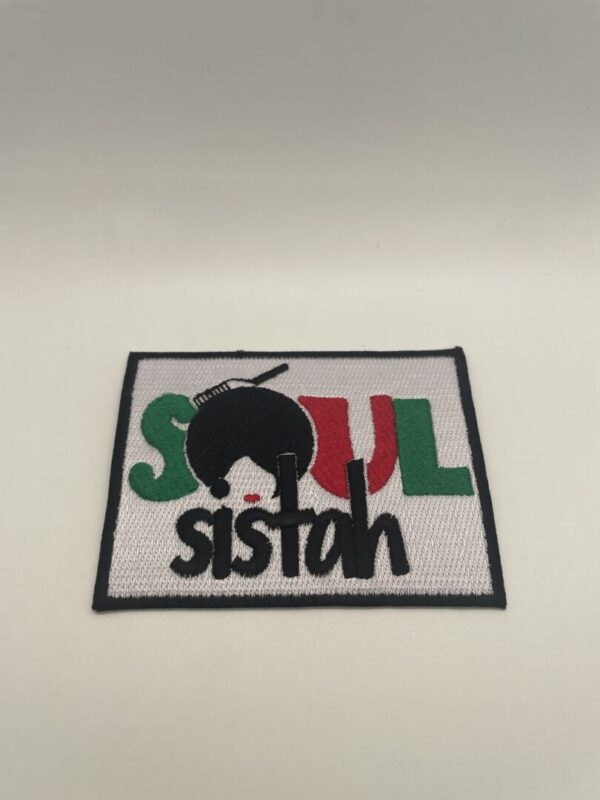 A patch that says soul sista on it.