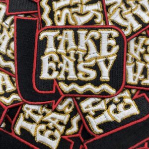 Embroidered patches with the phrase 'Take It Easy' in vintage style.