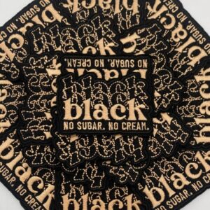 Stack of Black coffee packets arranged in a circular pattern.