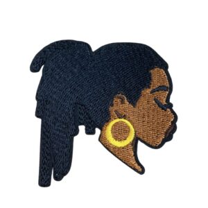 Profile of a woman with dark hair and large gold hoop earrings.