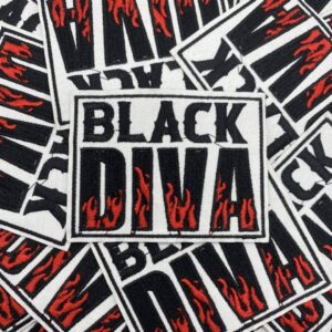 A pile of stickers reading 'BLACK DIVA' with red flames inside the letters.
