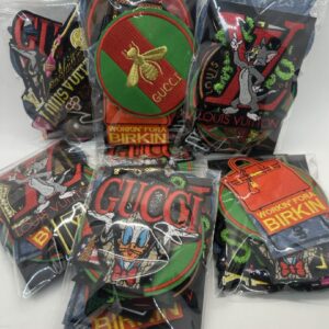 Multiple colorful Gucci-themed accessories in clear packaging.