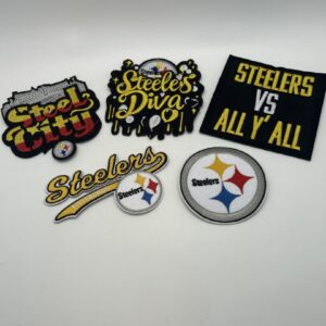 A collection of Pittsburgh Steelers patches and pins with team logos and slogans.